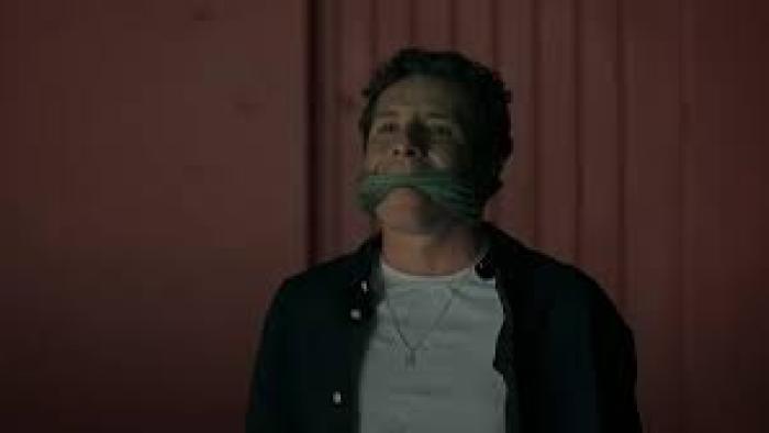 I Don't Expect Anyone to Believe Me scene 3: A man sits with a gag over his mouth