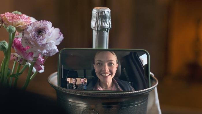 I Don't Understand You movie: Amanda Seyfriend beams on the screen of an iPhone screen that's sitting on a champagne bucket