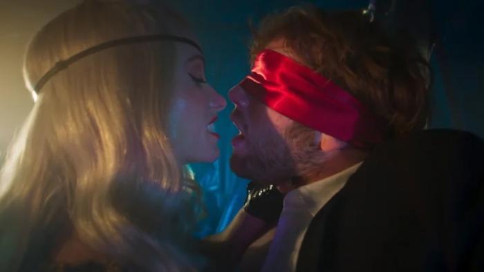 I Want Your Sex movie: Olivia Wilde grips Cooper Hoffman by the neck while he's wearing a red satin blindfold