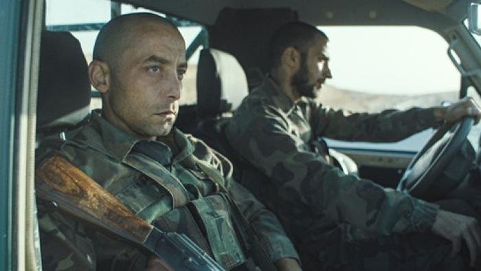 I Was a Stranger movie: Yahya Mahayni wears fatigues, riding in a car