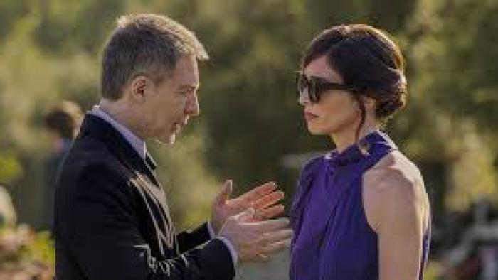 I Can't Live Without You: Man uses hands as he talks to a woman in purple
