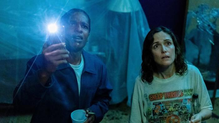 If I Had Legs I'd Kick You movie: A$AP Rocky aims a flashlight upward while he and Rose Byrne look shocked at what they see