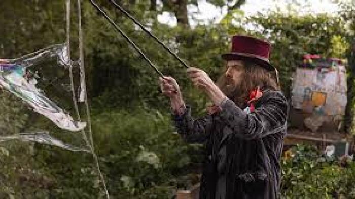 Bolan's Shoes: A bearded man creating a bubble