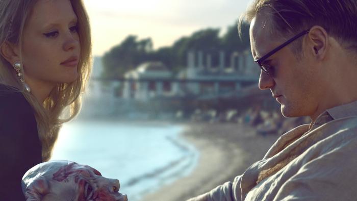 Infinity Pool Movie: Mia Goth is looking with confidence at Alexander Skarsgard by the pool