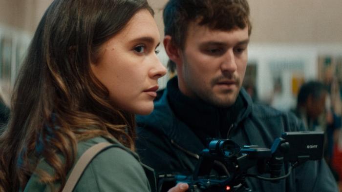 The Influencer Project Movie: Chiara King looks warily over her shoulder while Victor checks his camera