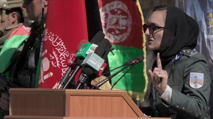Zarifa Ghafari addresses the public at a podium.