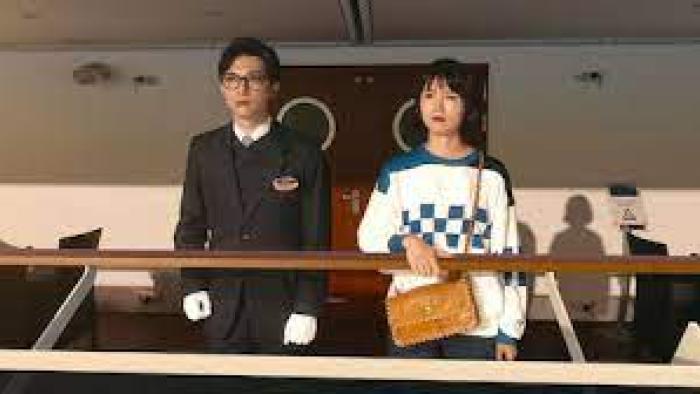 In Love and Deep Water: Asian man and woman stand om a ship's deck