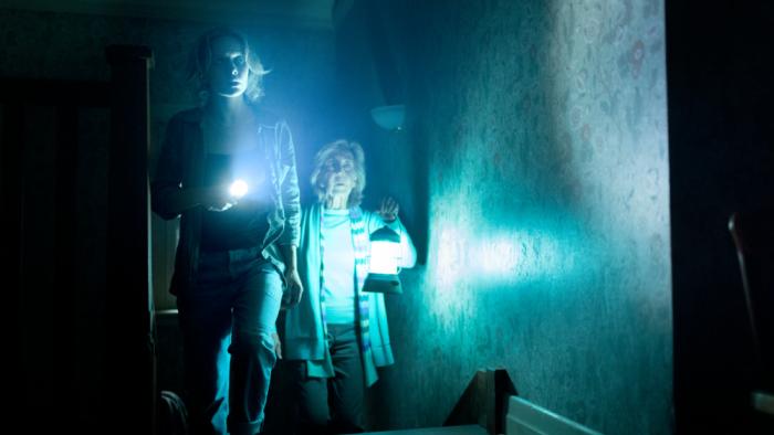 Insidious: Out of the Further Movie: Carrying flashlight and lantern, Gemma and Elise cautiously explore the Further