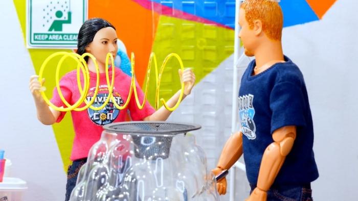 Inventors: Two dolls, one Asian woman, and a White man, work on an invention