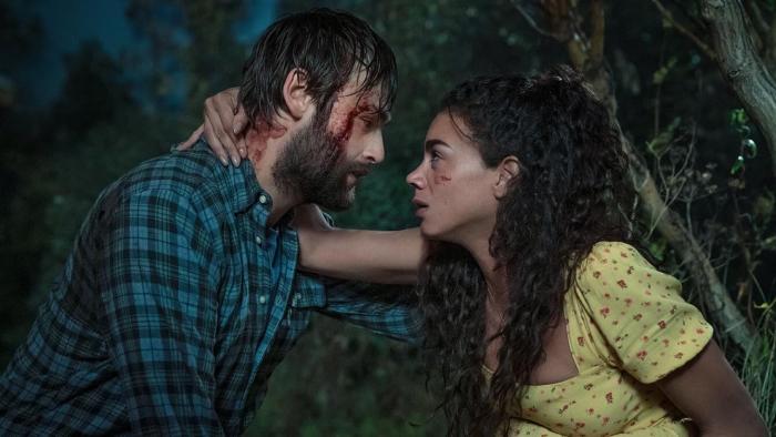 Unwelcome: A White man and a Black woman who are a couple, hold each other looking scared and with bloody injuries to the face 