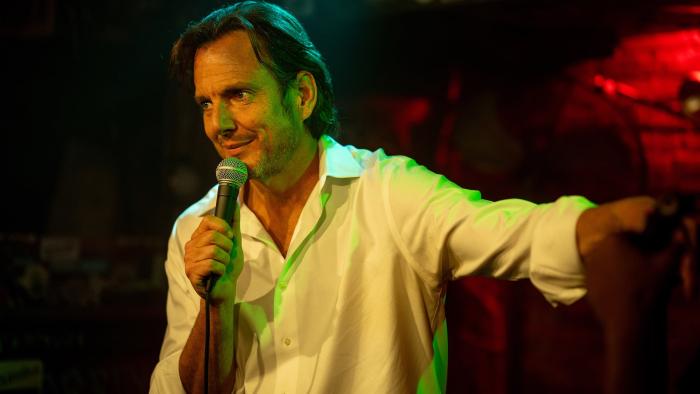 Is This Thing On? movie: Alex Novak (Will Arnett) is a stand-up comedian holding a microphone on stage