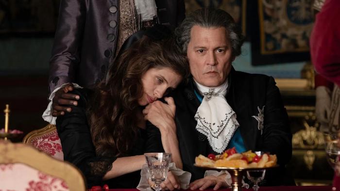 Jeanne du Barry movie: Wearing clothes of French aristocracy, Jeanne (Maiwenn) snuggles with King Louis XV (Johnny Depp)