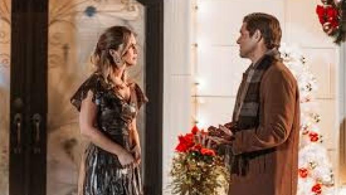 Joy for Christmas: Cindy Busby and Sam Page stand outside a front door