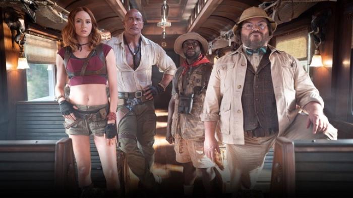 Jumanji: Open World Movie: Characters stand confidently inside a vintage train car
