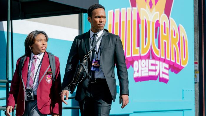 K-POPS! movie: Anderson .Paak and Soul Rasheed walk through a TV studio lot, with the "Wildcard" show logo behind them