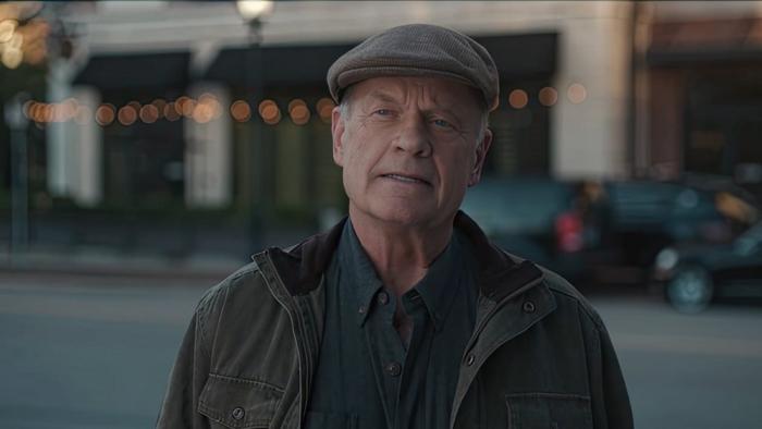 Karen Kingsbury's The Christmas Ring movie: Kelsey Grammer stands in the street looking up at his shop, off camera