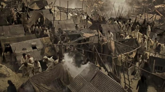 K.G.F -- Chapter 1: An aerial shot of a camp of enslaved workers