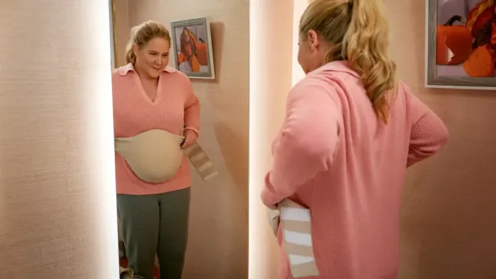 Kinda Pregnant: Amy Schumer looks in the mirror.
