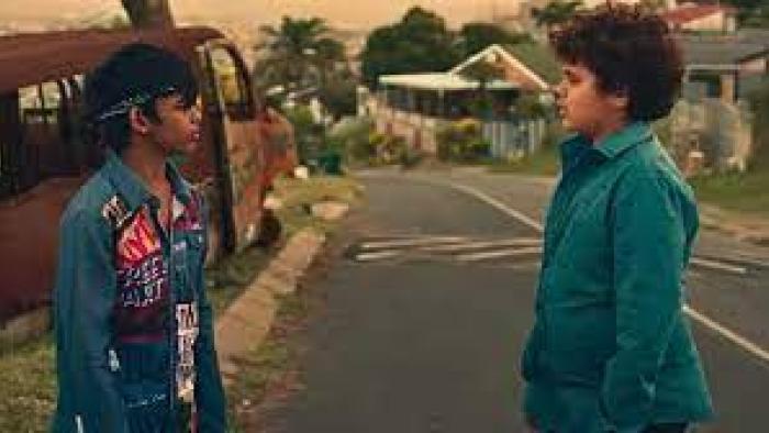 Kings of Mulberry Street: Let Love Reign: An Indian South African boy in colorful jean jacket left faces an Indian South African boy in plain jean jacket right