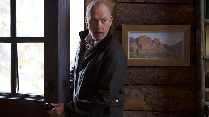 Knox Goes Away Movie: Knox (Michael Keaton) slips inside a doorway, looking as if he's breaking in and trying to be cautious