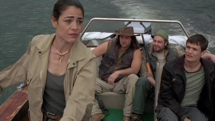 Lake Placid 3: Woman steering a boat with three men seated behind her.