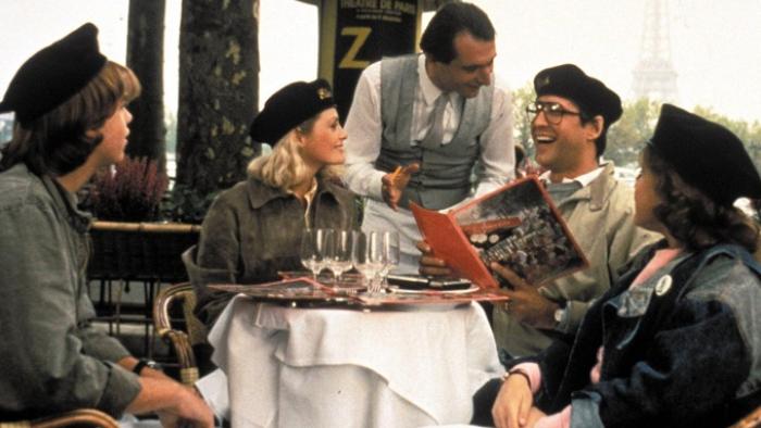 National Lampoon's European Vacation Movie: Outdoor restaurant scene with the Eiffel Tower in background -- the Griswolds wear berets and speak with a waiter