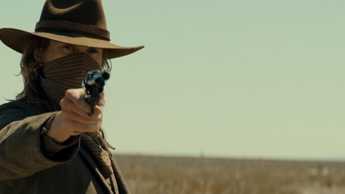 Last Train to Fortune Movie: A masked Dooley points a gun at someone
