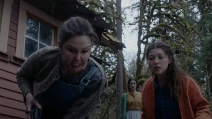 Lazareth movie: Ashley Judd angrily holds a gun outswide of Lazareth with Katie Douglas looking frightened 