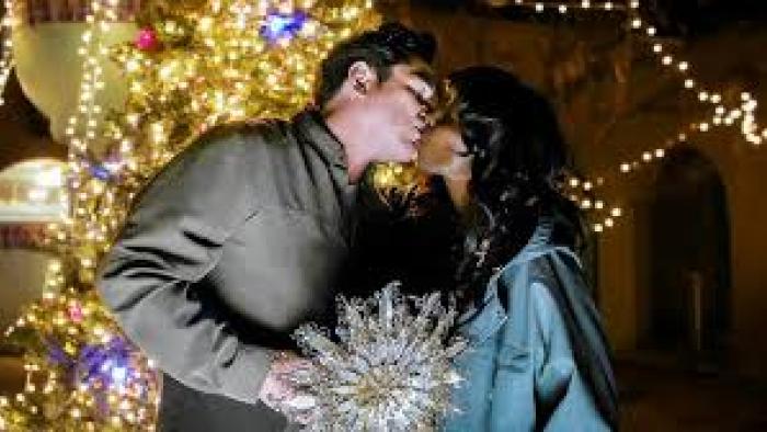 Letters at Christmas: White man and Black woman kiss by Christmas tree