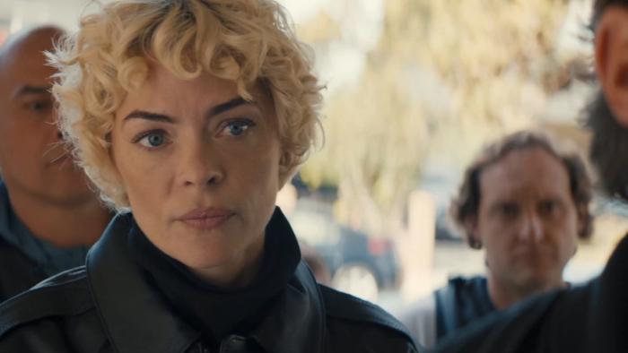 Lights Out Movie: Crooked police officer Detective Ellen Ridgway (Jaime King), surrounded by other officers, prepares to search the home of Max's sister