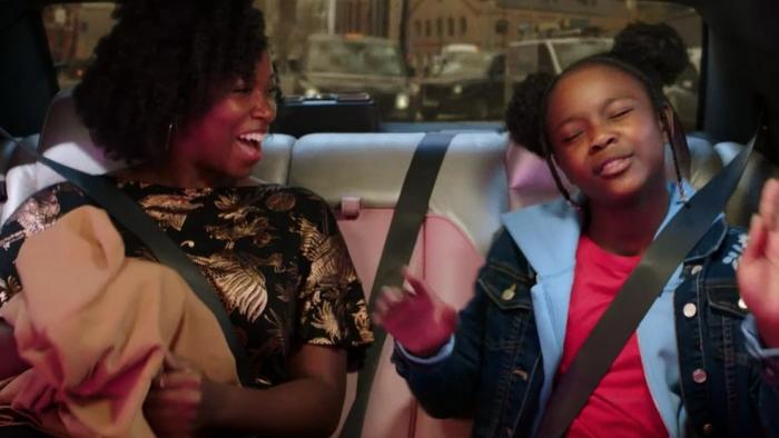 Little Darlings: The Movie: Destiny and her mum laugh in the back of a car