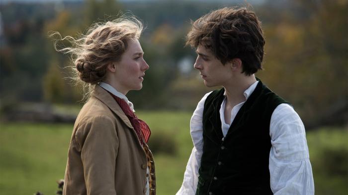 Little Women (2019) Movie: Jo and Laurie face each other in a field