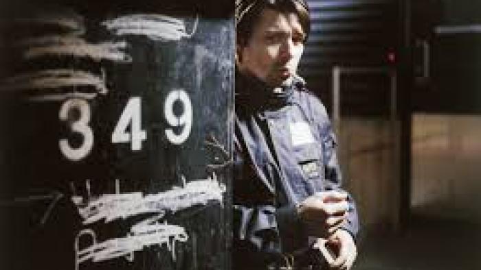 Little Siberia: man with cigarette behind pole