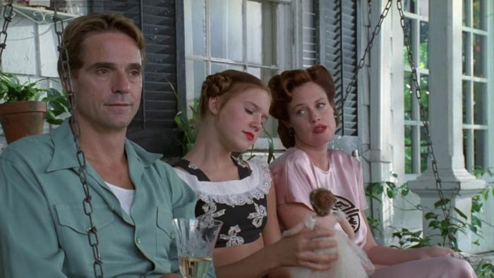 Lolita: Jeremy Irons, Dominique Swain, and Melanie Griffith sit on a swing seat together
