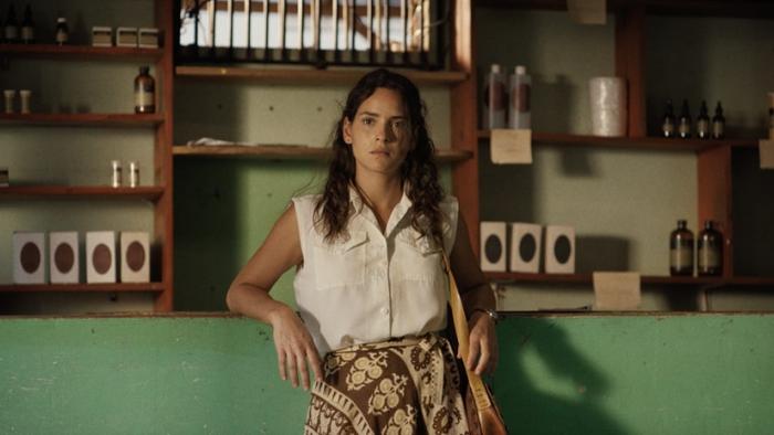Los Frikis movie: Adria Arjona leans on a counter