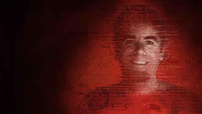 Love, Ted Bundy movie: a smiling headshot of Ted Bundy on a red photo background