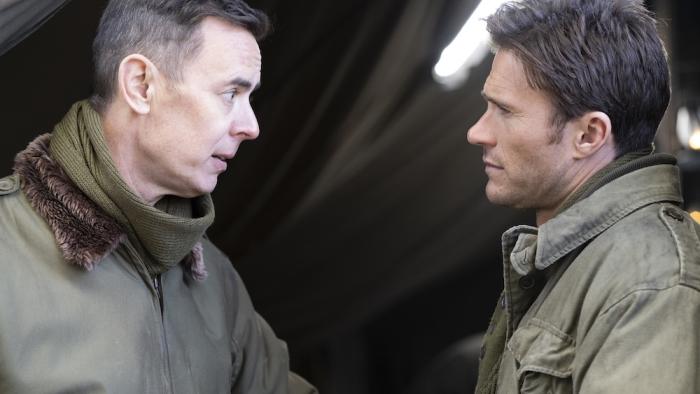 Lucky Strike Movie: Col. Neale (Colin Hanks) speaks seriously to Col. Castle (Scott Eastwood) outside a tent