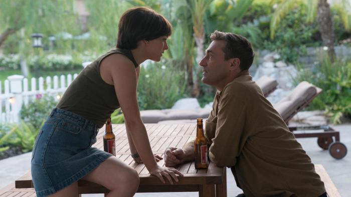 Lucy in the Sky Movie: Lucy and Mark stare at each other over a picnic table