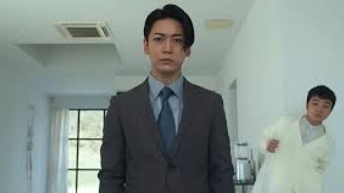 Lumberjack the Monster: Asian man in suit with man in white behind him