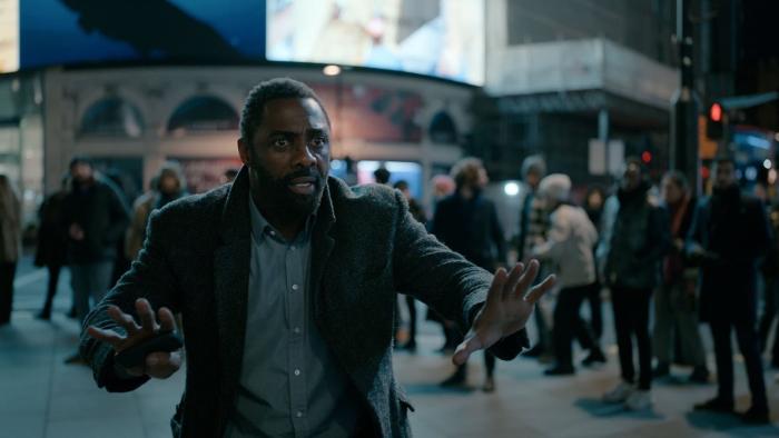 Luther - The Fallen Sun: Idris Elba as John Luther has his hands out in front of him calling for calm in nighttime London