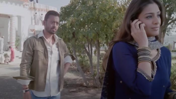 Maqbool: Nimmi talks on the phone while Maqbool waits, watching her