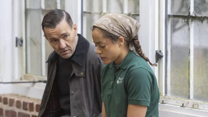Master Gardener Movie: Sitting by a window, Narvel talks seriously with Maya