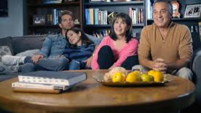 Menorah in the Middle: Family gathers on sofa 