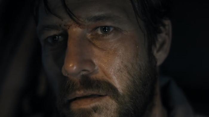 Mercy Road: A close-up of a dishevelled, bearded White man in a car.