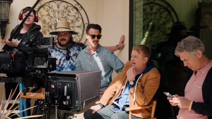 Micro Budget Movie: Director Terry is seated, fourth from the right, while various crew members surround him