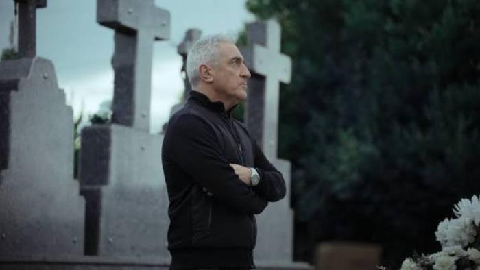 Miguel Ángel Blanco: The 48 Hours that Changed Spain Movie: Older man standing arm-crossed in a cemetery beside tall gravestones.