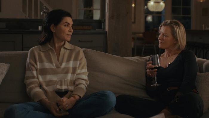 Millers in Marriage movie: Julianna Marguiles and Gretchen Mol sit on a couch, facing each other