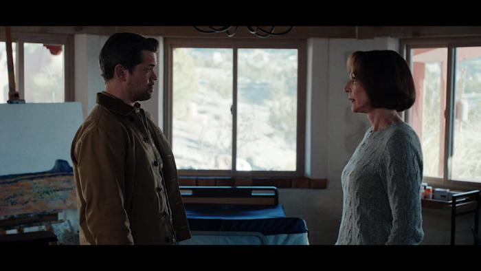 Miss You, Love You movie: Andrew Rannells and Allison Janney stand facing each other in a dark room