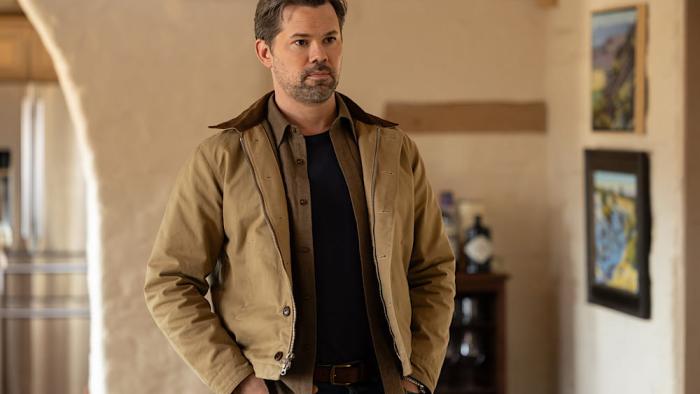 Miss You, Love You: Andrew Rannells stands in a house with his hands in his pockets
