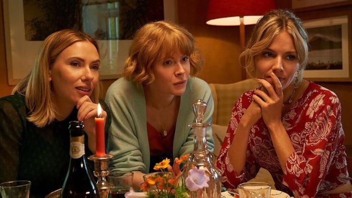 My Mother's Wedding: Scarlett Johansson, Emily Beecham, and Sienna Miller sit together leaning their elbows on a kitchen table